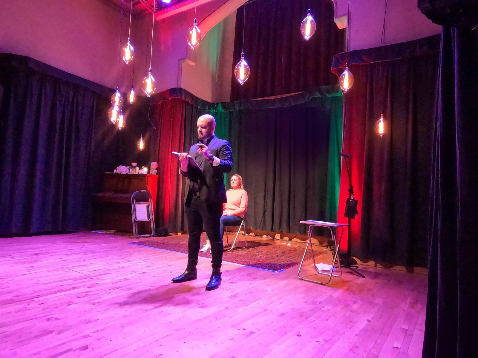 David Peace on stage with a microphone during a performance